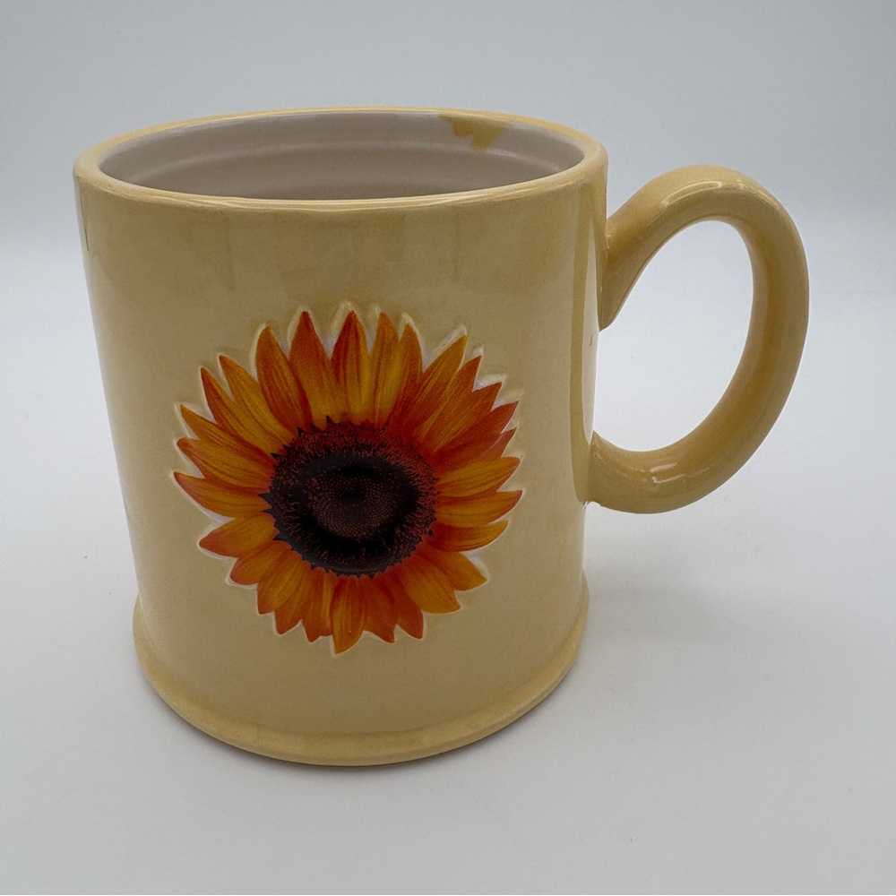 The Old Pottery Company Yellow Mug with an Embossed Raised Sunflower Design